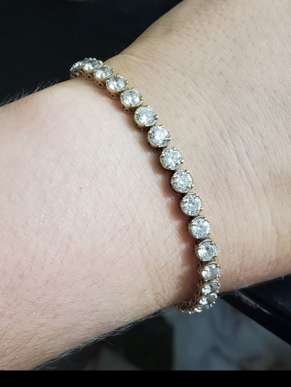 Sterling silver CZ bracelet. This has a gold wash so it's gold in color. Lots of